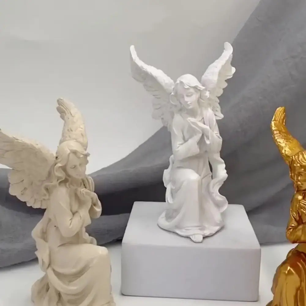 White angel figurine with detailed wings and flowing robes seated on square base collectible statue for home decor