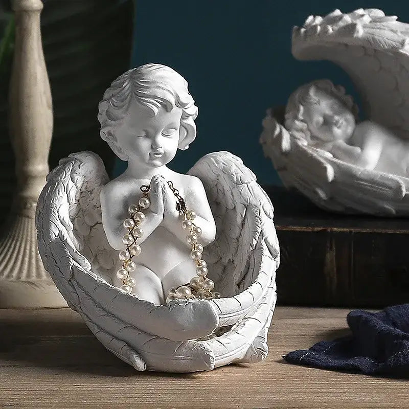 White angel girl resin figurine with detailed wings and clasped hands holding pearl necklace for modern decor