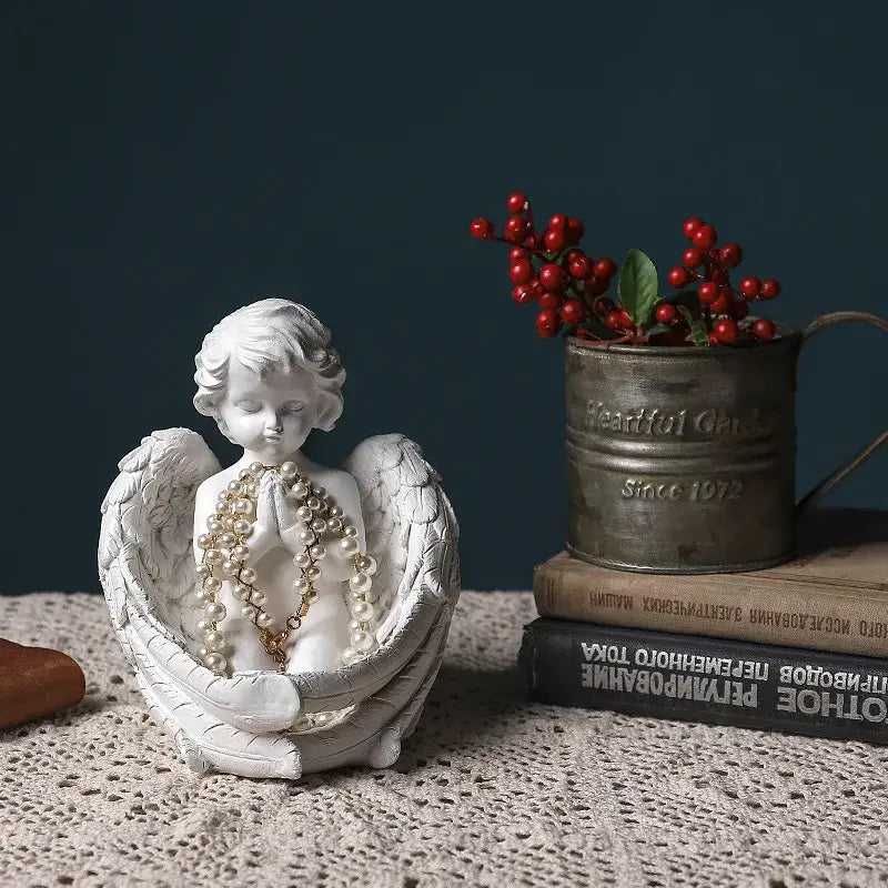 White angel girl resin figurine with detailed wings and clasped hands holding pearls for modern home decor