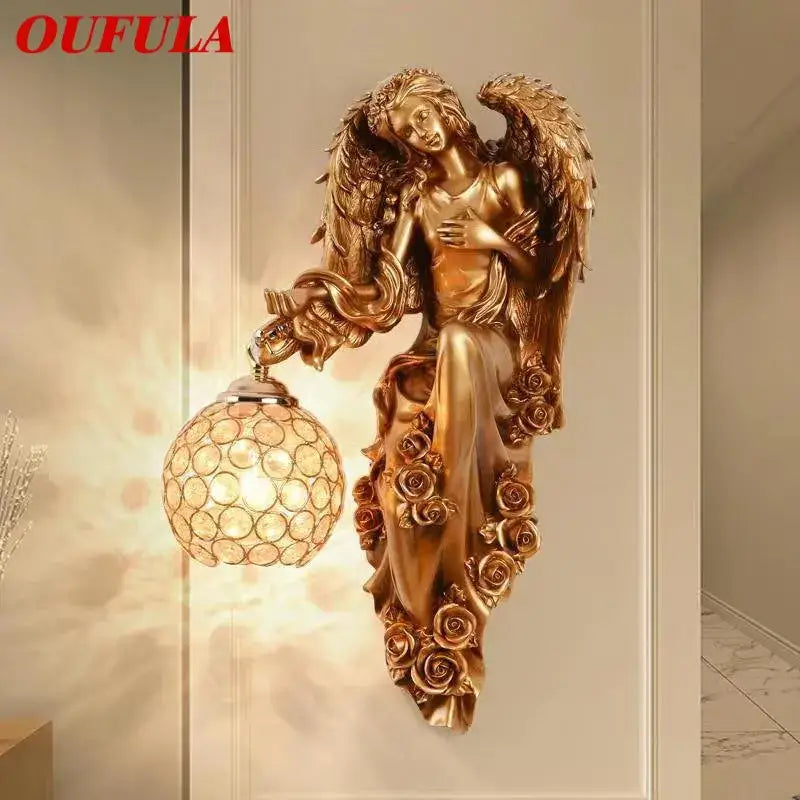 Golden angel indoor wall light led in gold resin with intricate wing and rose design and spherical crystal globe shade