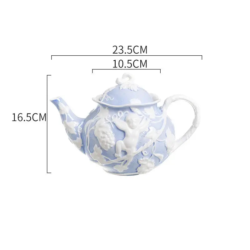 A delicate light blue porcelain teapot with intricate white angel relief ceramic detailing from DecorBites™ tableware set