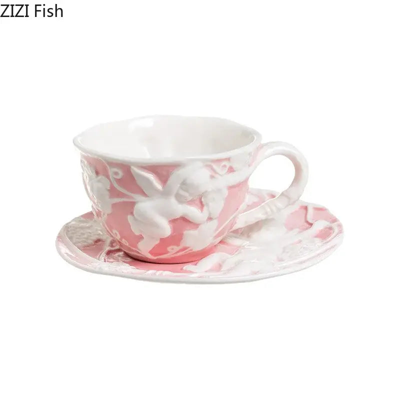 Pink ceramic teacup with white angel relief floral design and matching saucer from decorbites angel relief ceramic tableware set
