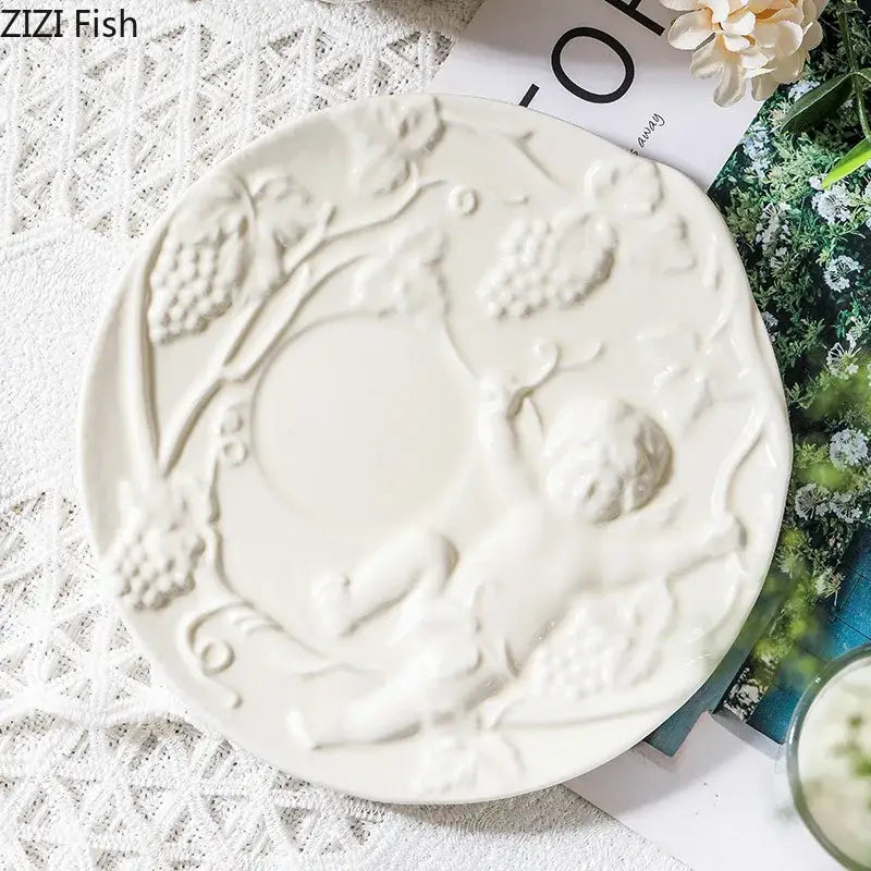 White ceramic plate with raised angel relief ceramic design of grapes and vines from decorbites relief ceramic tableware set
