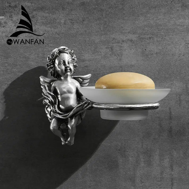 Silver angel style gold soap dish with frosted white ceramic tray holding pale yellow soap for bathroom use