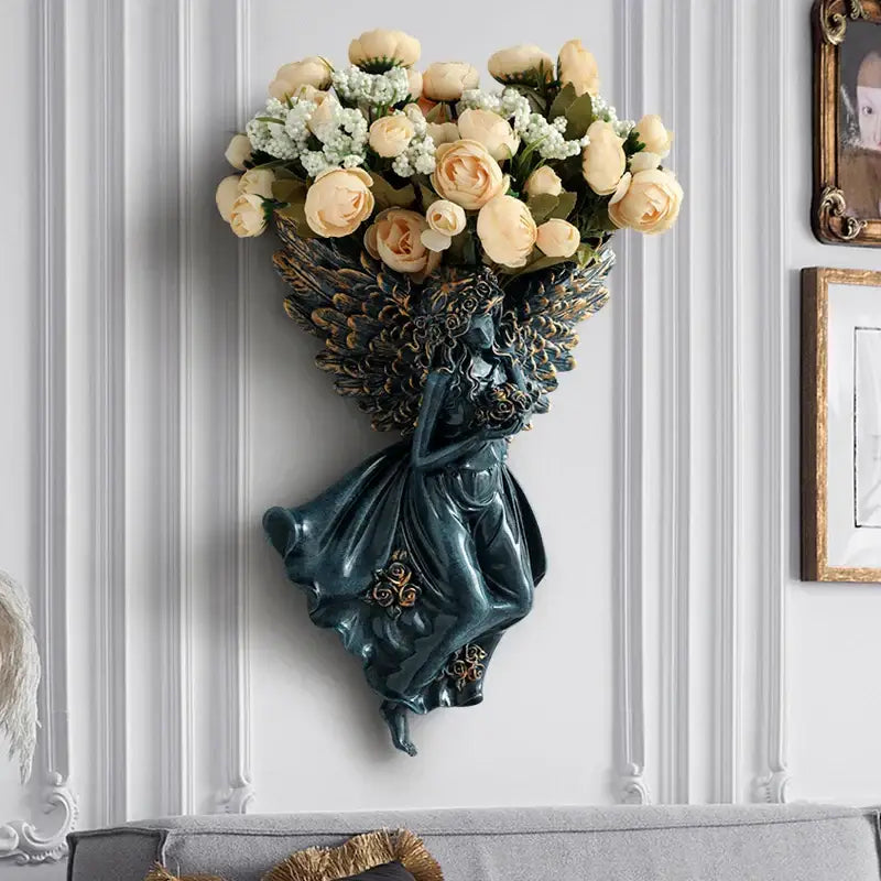 Dark green resin angel vase wall decoration with ornate wings holding cream roses for living room shelf art