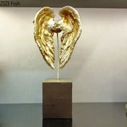 DecorBites angel wings sculpture features textured metallic golden wings on a dark brown base for desk decor