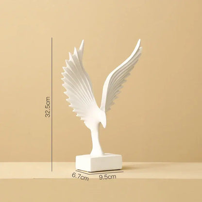 White ceramic angel wings sculpture with detailed outstretched wings on a sleek base by DecorBites™