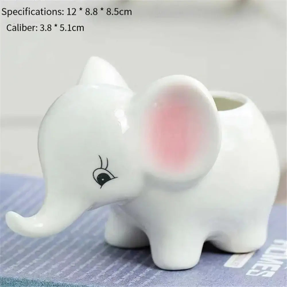 White ceramic animal cartoon ceramic elephant planter with pink inner ear and black eyelash detail for nursery planting