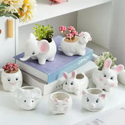 White ceramic animal cartoon ceramic flowerpots with pink accents and cute facial features for nursery planting