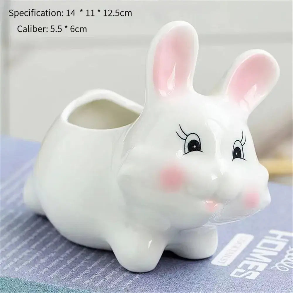 White ceramic animal cartoon flowerpot with pink ears rosy cheeks and black embroidered eyes for nursery planting