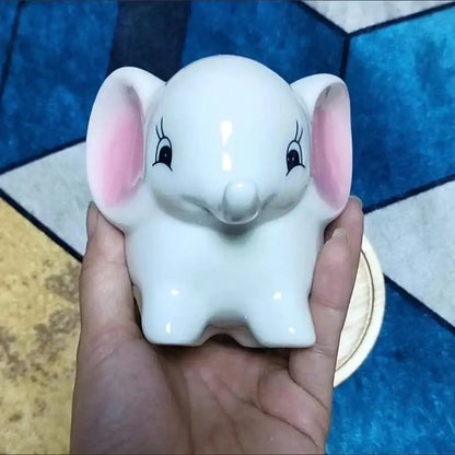 White ceramic elephant piggy bank with pink ears and black eyelashes in decorbites animal cartoon ceramic flowerpot design