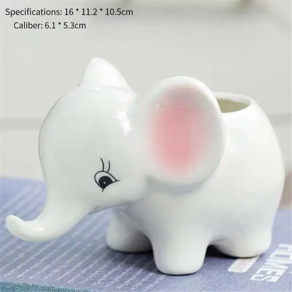 White ceramic animal cartoon toothbrush holder with pink inner ear and black embroidered eye from decorbites cartoon ceramic flowerpot collection