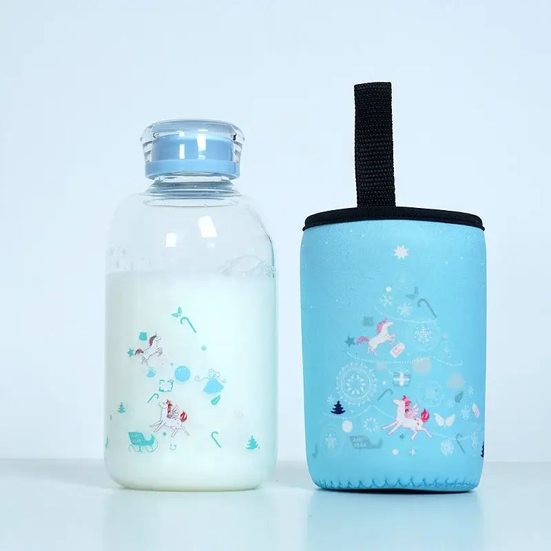 Clear glass water bottle with light blue lid and unicorn decals paired with matching neoprene sleeve for outdoor use