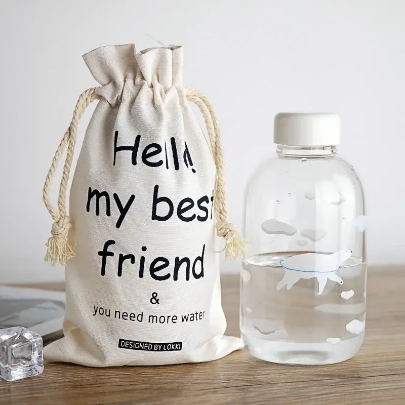 Cream-colored cotton drawstring bag with black text for DecorBites glass water bottle sleeve designed by lokki