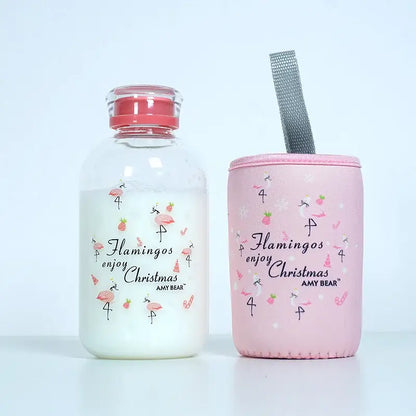 DecorBites™ glass water bottle with pink flamingo-themed insulated sleeve and silver mesh strap for outdoor use