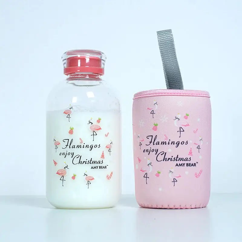 DecorBites™ glass water bottle with pink flamingo-themed insulated sleeve and silver mesh strap for outdoor use