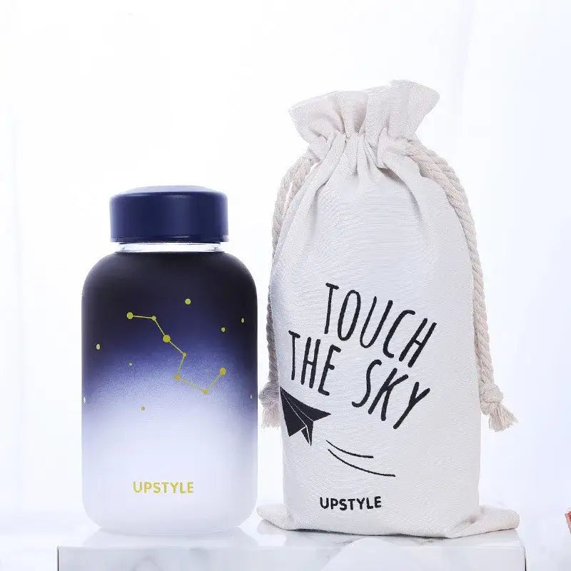 Navy blue and white gradient glass water bottle with gold constellation design and dark blue lid by upstyle for outdoor use