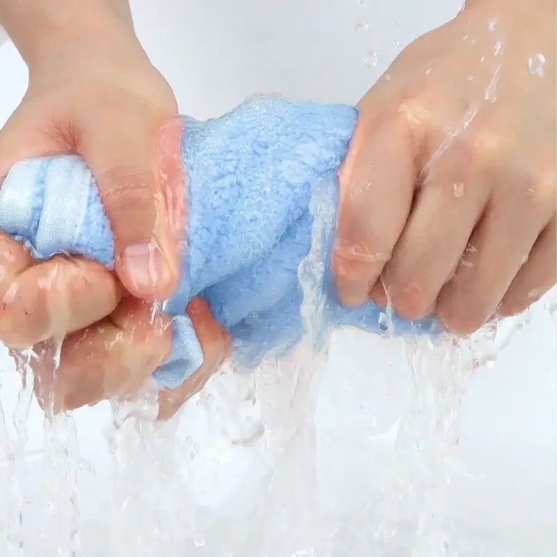 Blue microfiber hand towel from decorbites animal hand towel set being squeezed in water showing soft terry material