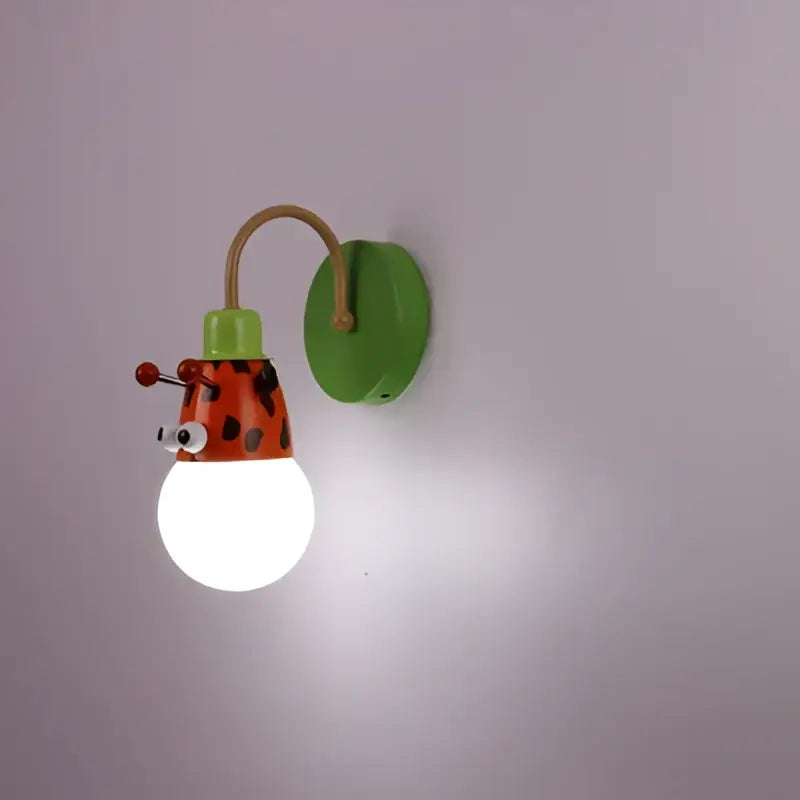 Decorbites animal led ceiling light featuring a whimsical green and orange ladybug wall sconce with brass arm