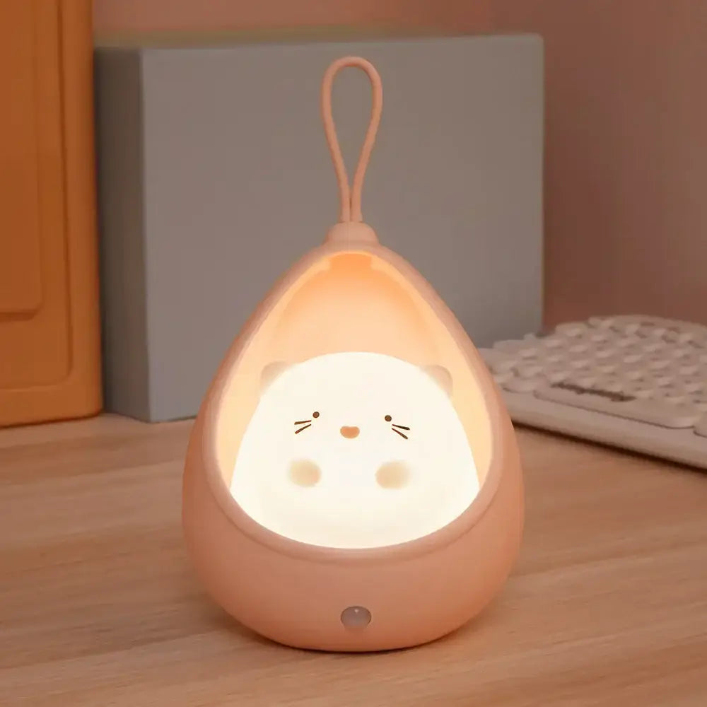 DecorBites™ soft peach silicone animal night light with sensor control featuring a white hamster face, USB rechargeable
