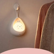 White ceramic wall-mounted animal night light with bunny face emitting warm glow usb rechargeable silicone led sensor control