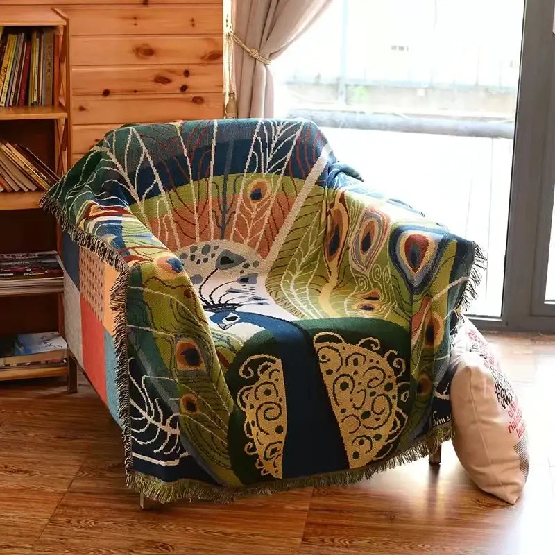 DecorBites™ animal pattern throw blanket featuring a vibrant peacock pattern with fringe in green blue and gold tones