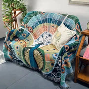 DecorBites™ animal pattern throw blanket with vibrant peacock design, tassels, and teal green gold cream colors