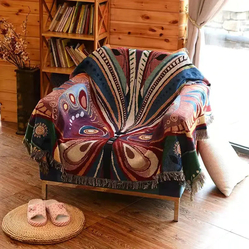 Decorbites™ animal pattern throw blanket with vibrant butterfly design in purple and earth tones draped on armchair