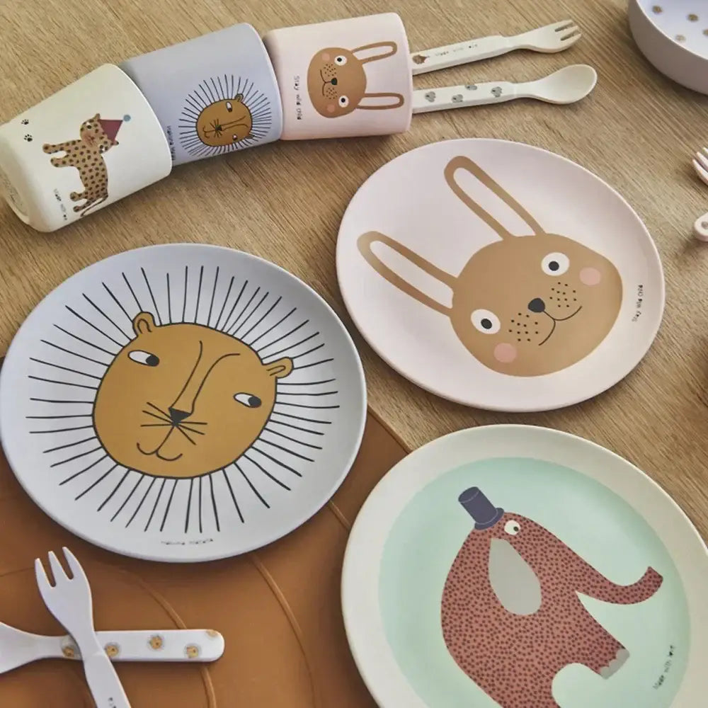 Pastel-colored animal print bamboo fiber children’s dinnerware set with playful animal illustrations on plates and cups