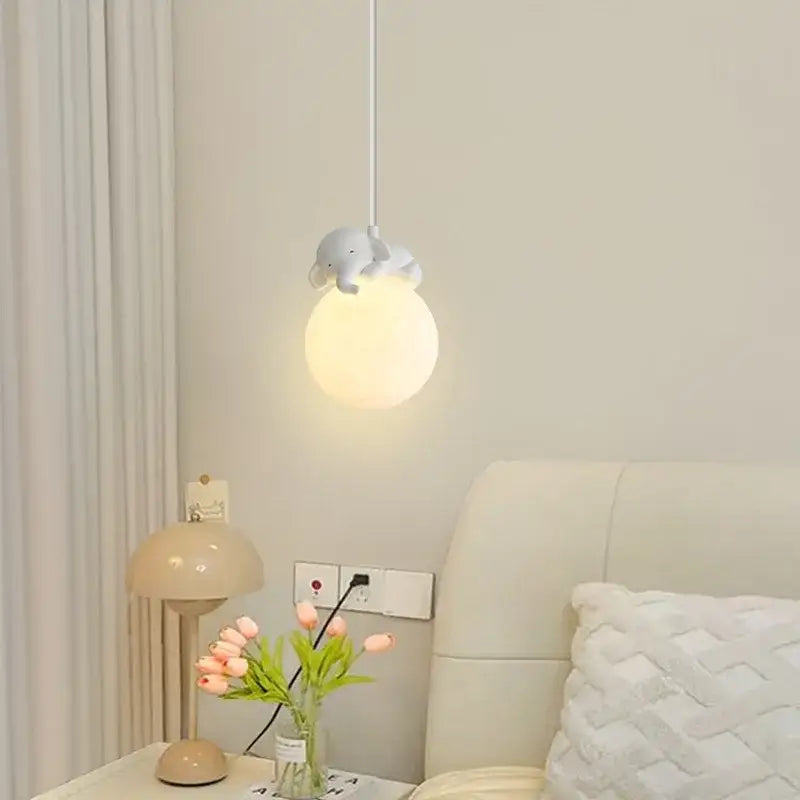 Decorbites animal resin pendant lamps featuring a soft spherical pendant light with a gray elephant resin figurine