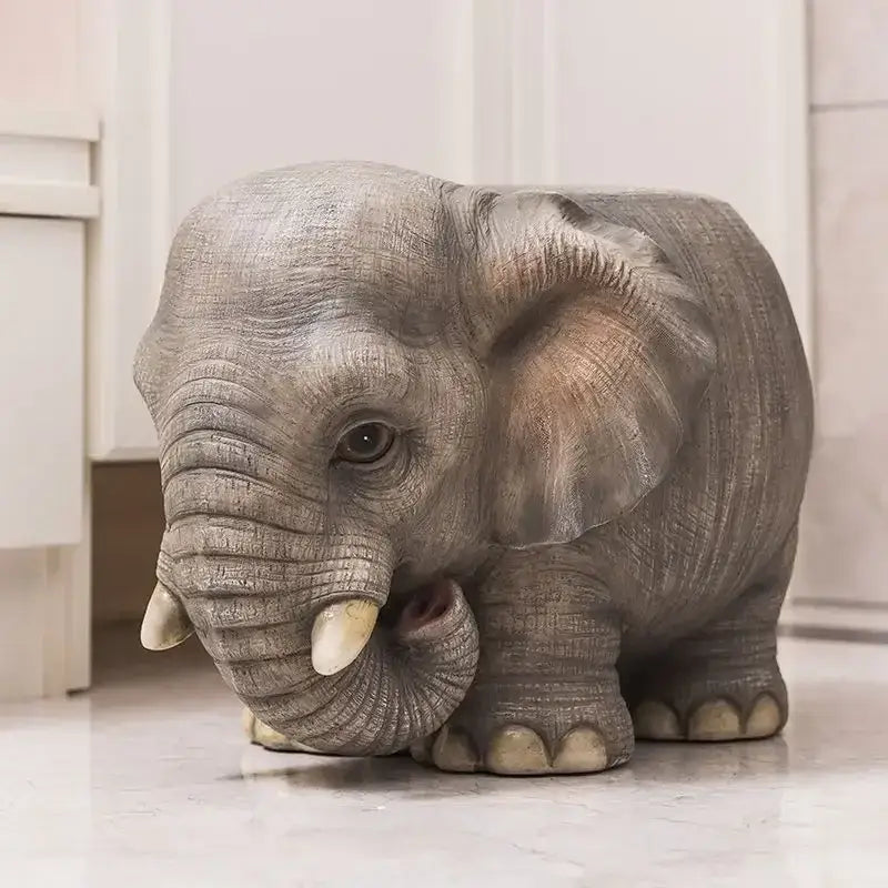 Gray elephant-shaped animal resin sculpture footstool seat with textured skin and white tusks for living room decor