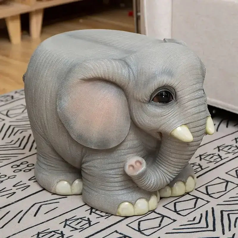 Gray elephant resin sculpture footstool seat with detailed textured skin and pink ears on patterned surface for living room