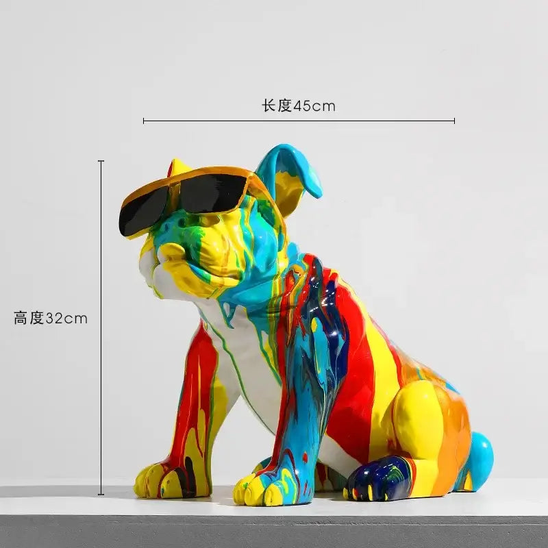 A vibrant animal resin statue of a seated french bulldog with colorful paint splashes and black sunglasses from DecorBites resin statue collection