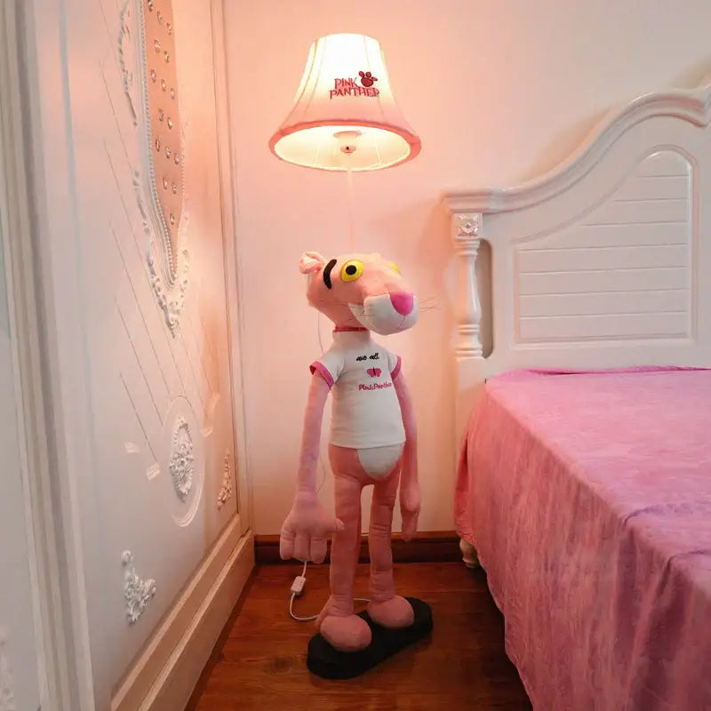 Pink panther plush figure in white t-shirt standing on black base next to decorbites™ animal shape led floor lamp for children