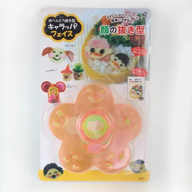 Orange flower-shaped rice mold with central indentation and face-shaping protrusions for decorbites animal shape sushi mold set