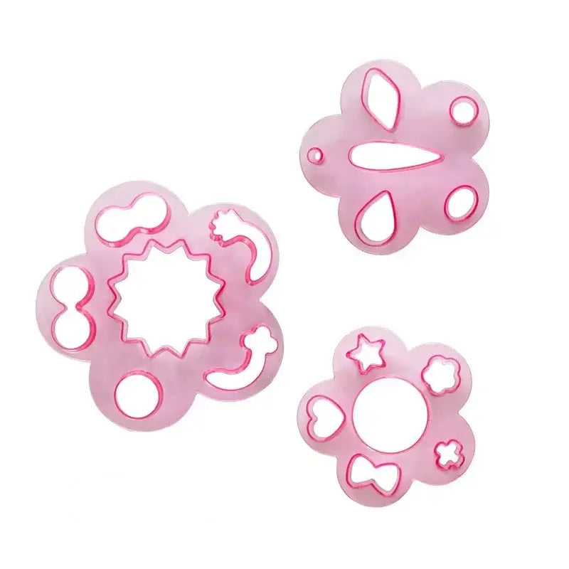 Pink flower-shaped cookie cutters with intricate designs and shiny edges in decorbites mold set for animal shape sushi rice