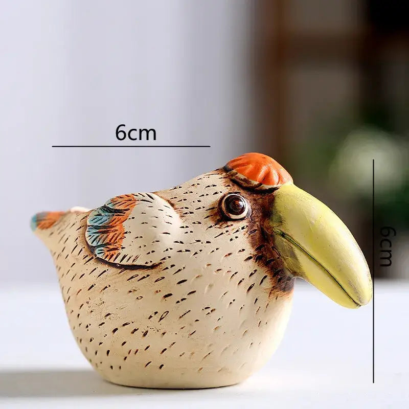A 6cm ceramic cream animal vase succulent pot with speckled texture and vibrant orange toucan accents