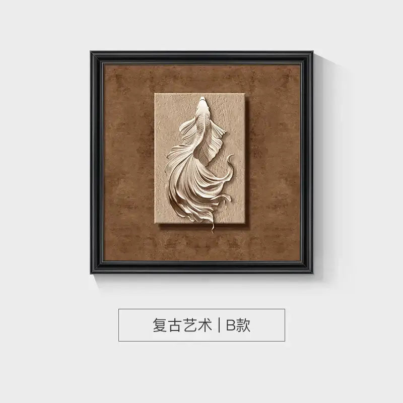 A cream-colored 3d fish sculpture on a textured beige panel in a sleek black animal wall decor frame set by decorbites