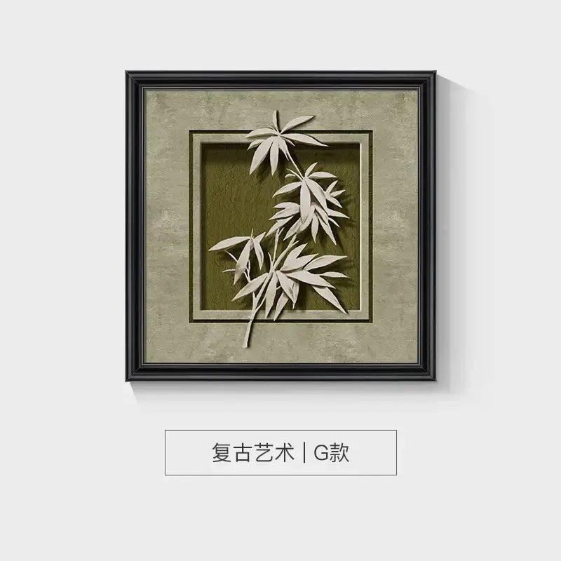 Black-framed square wall decor frame set featuring three-dimensional white paper bamboo leaf on olive green background