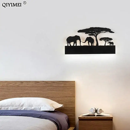 Black metal animal wall lamps featuring elephant and acacia tree silhouettes with warm upside and cool down lighting