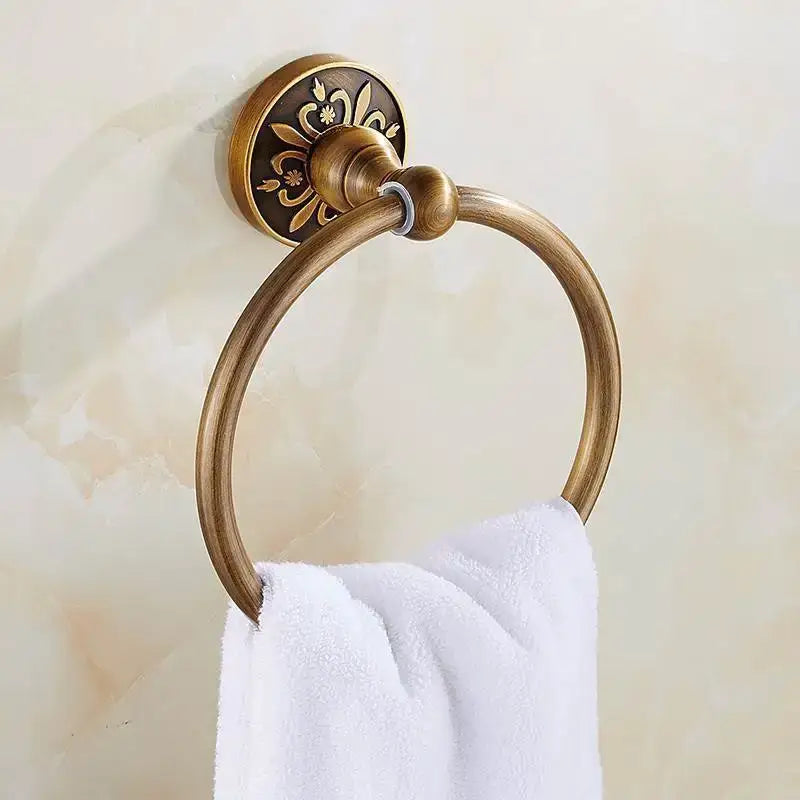 Antique brass towel ring with ornate floral engraving on mounting plate in decorbites bath hardware and towel rack set