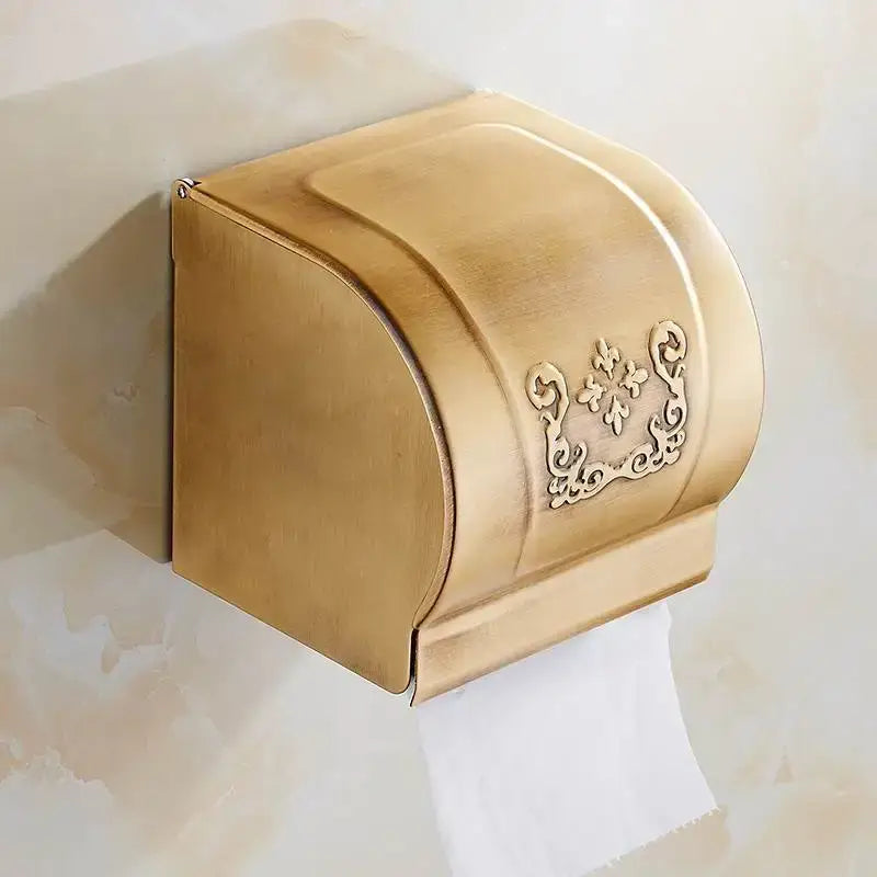 Gold-toned brass toilet paper holder with ornate floral embossing from DecorBites bath hardware towel rack set
