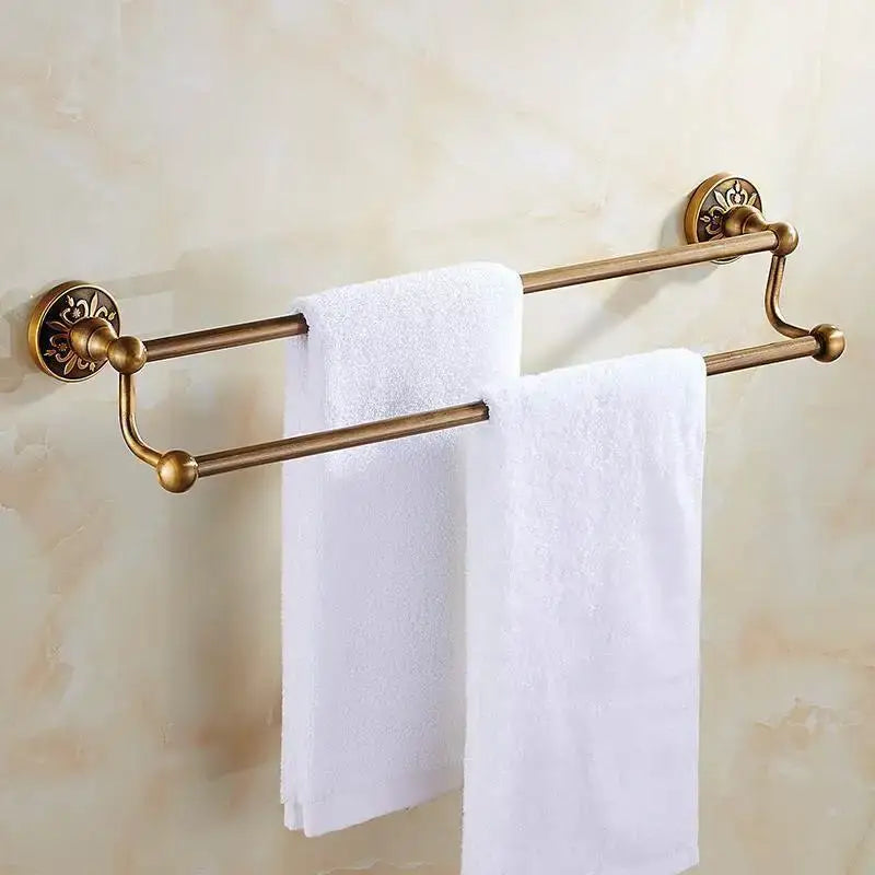 Antique brass double towel rack with ornate floral mounts and polished finials for bath hardware and toilet brush holder