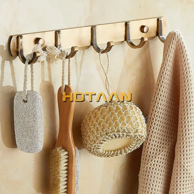 Bronze-colored metal wall-mounted decorbites antique black robe hook rack with five hooks holding bath accessories