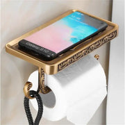 DecorBites antique black toilet paper holder with ornate brass scrollwork and integrated phone shelf for bathroom use