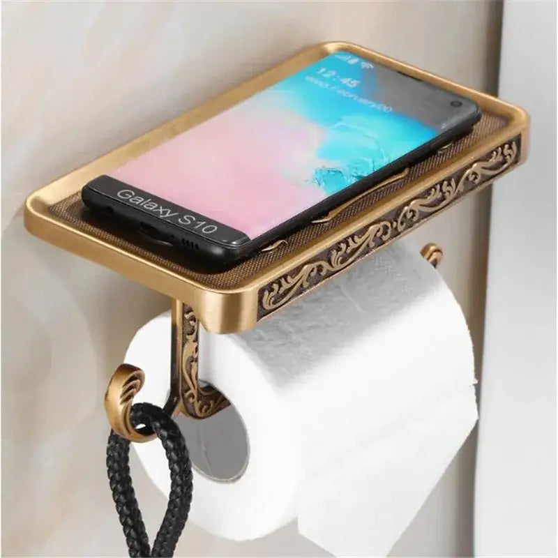 DecorBites antique black toilet paper holder with ornate brass scrollwork and integrated phone shelf for bathroom use