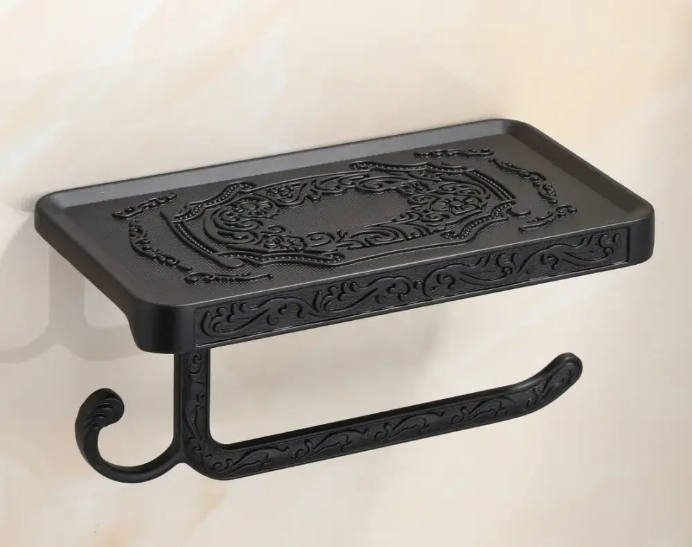 DecorBites antique black metal toilet paper holder with ornate floral embossing and phone shelf for bathroom use