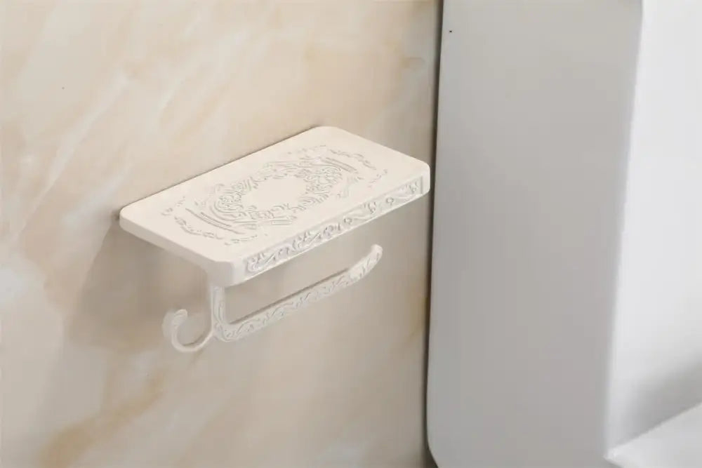 White plastic toilet paper holder with ornate embossed floral and scrollwork design for antique black style decor