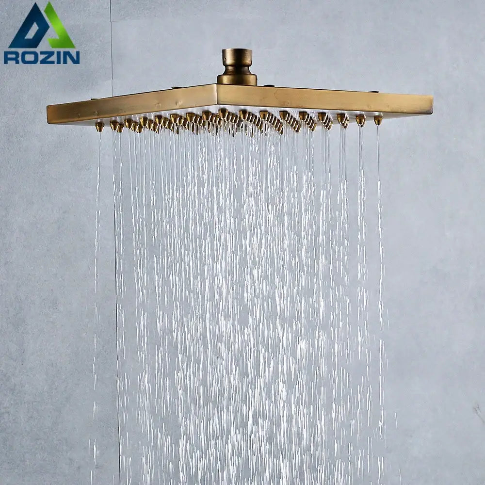 Decorbites antique brass 8-inch square rainfall shower head with multiple nozzles spraying water in antique brass finish