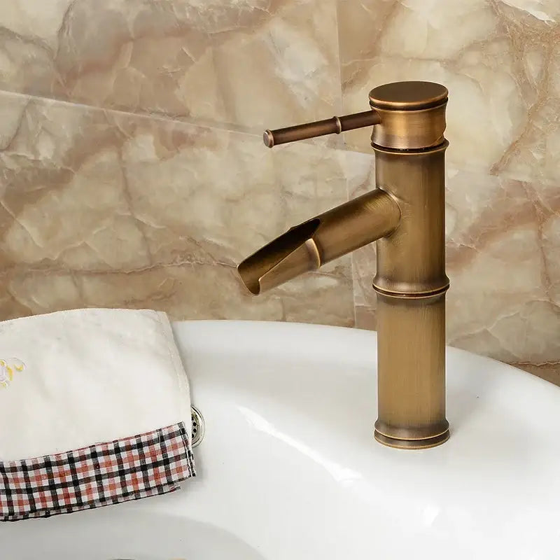 Decorbites antique brass bamboo basin faucet single handle with curved spout in antique brass finish for bathroom use